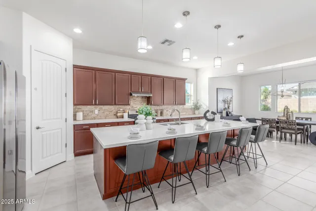 a bedroom with a large bed and a chandelier