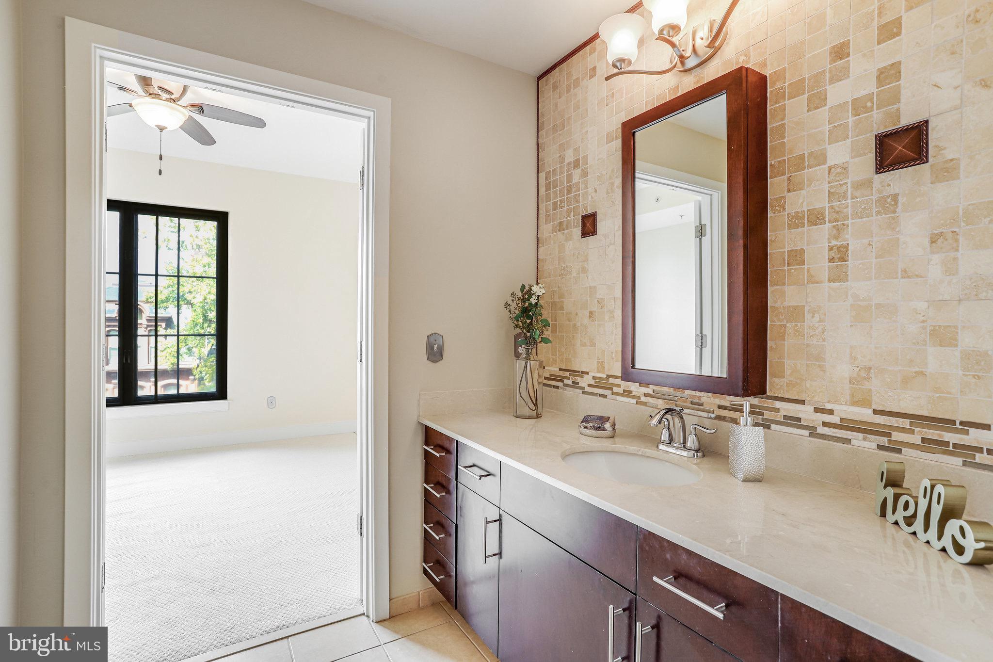 910 M Street Northwest, Unit 516 Washington, DC 20001 - Photo 12 of 29 a bathroom with a sink vanity and a mirror