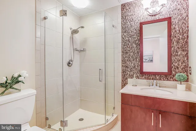 a bathroom with a shower sink and mirror