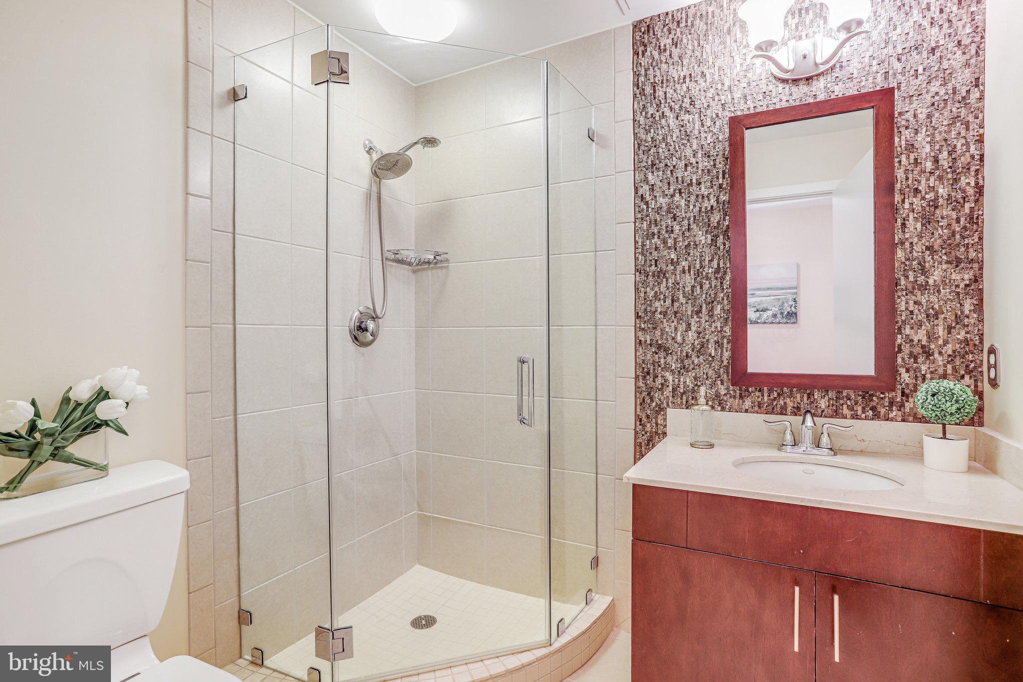 910 M Street Northwest, Unit 516 Washington, DC 20001 - Photo 15 of 29 a bathroom with a shower sink and mirror