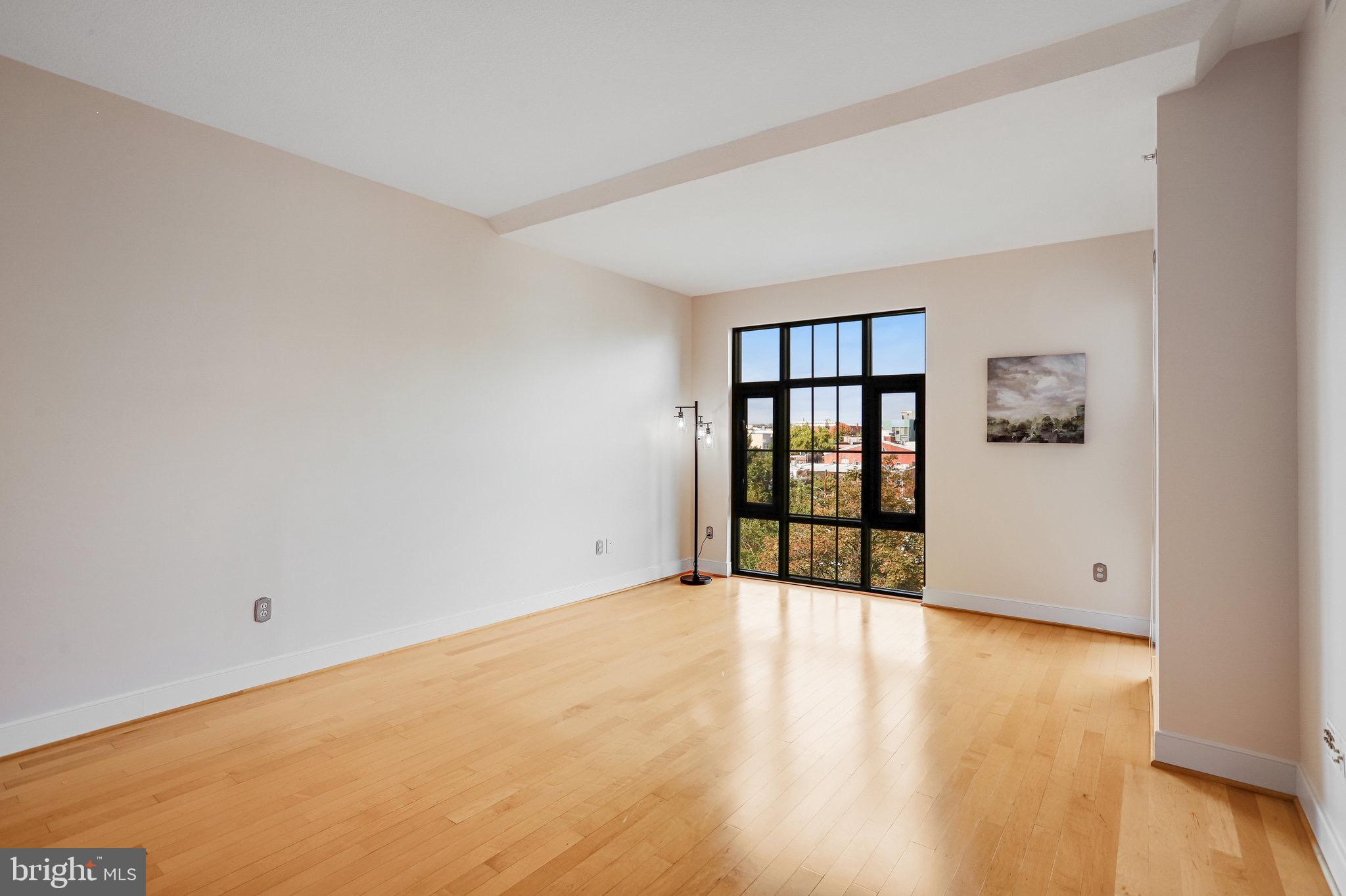 910 M Street Northwest, Unit 516 Washington, DC 20001 - Photo 2 of 29 wooden floor in an empty room with a window