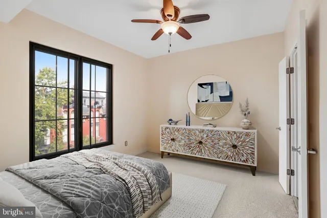 a bedroom with a bed table and window