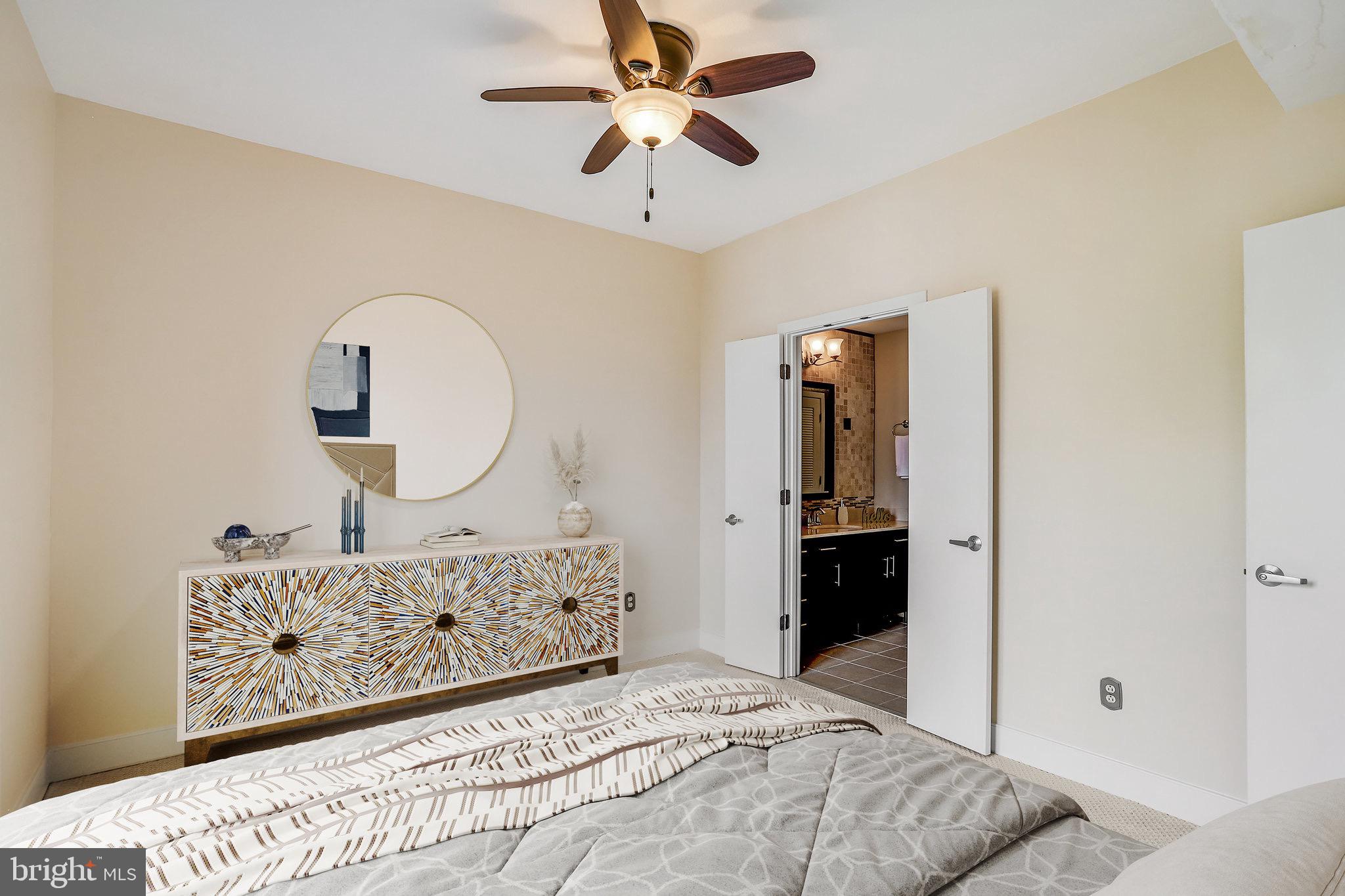 910 M Street Northwest, Unit 516 Washington, DC 20001 - Photo 10 of 29 a bedroom with a bed a dresser and mirror