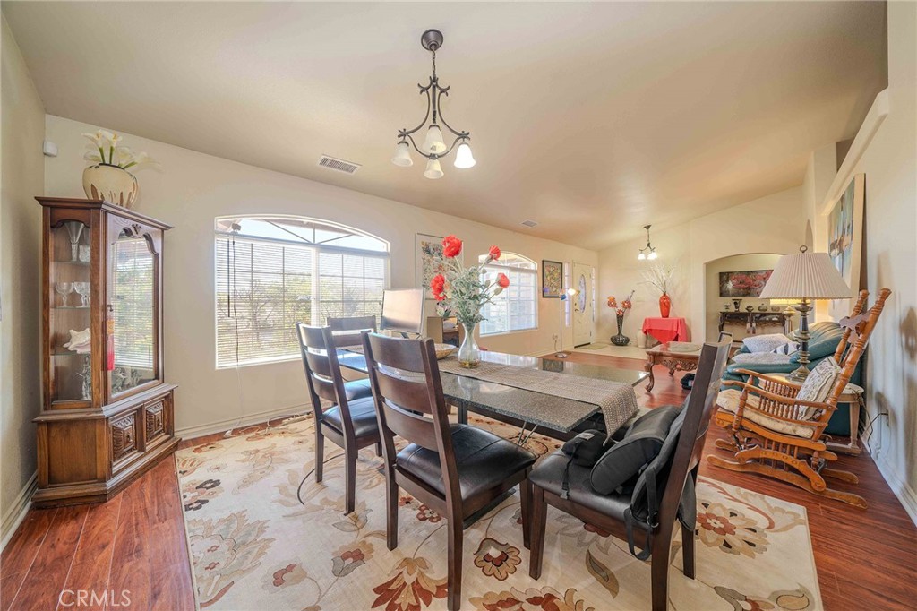 11522 Ponderosa Road Pinon Hills, CA 92372 - Photo 15 of 46 a view of a dining room with furniture window and wooden floor