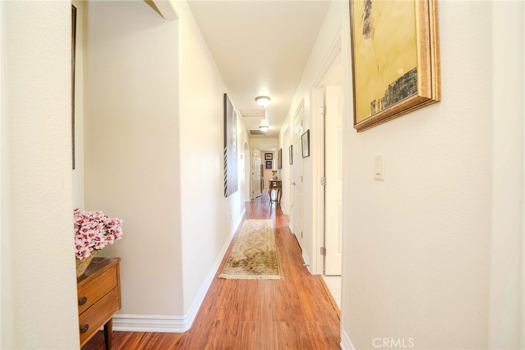 11522 Ponderosa Road Pinon Hills, CA 92372 - Photo 21 of 46 a view of a hallway with wooden floor and furniture