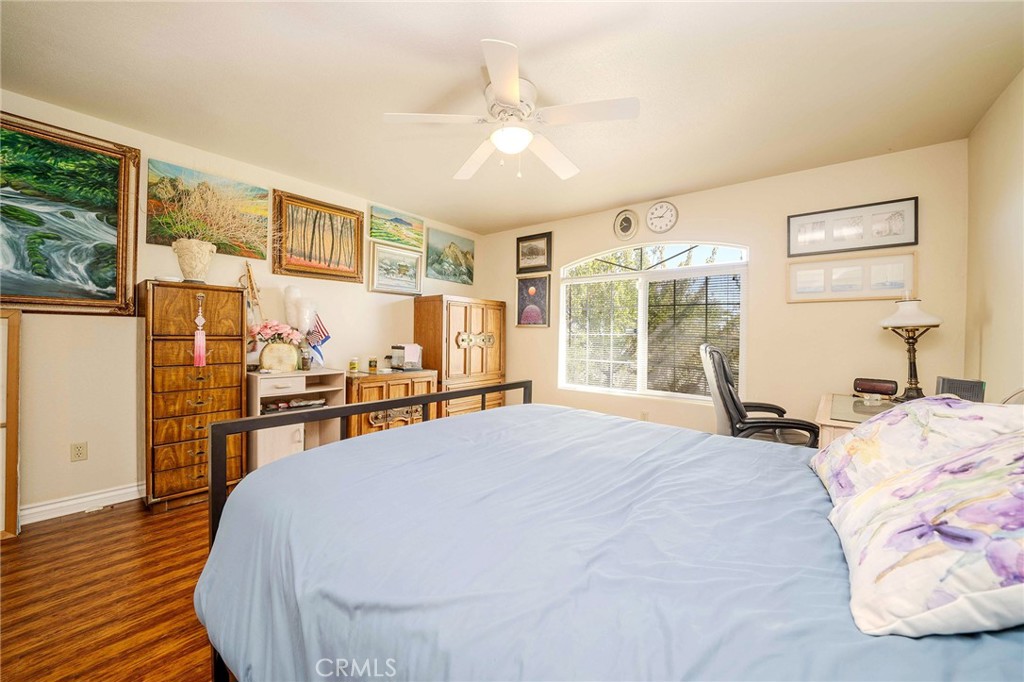 11522 Ponderosa Road Pinon Hills, CA 92372 - Photo 25 of 46 a bed room with a bed and a large window