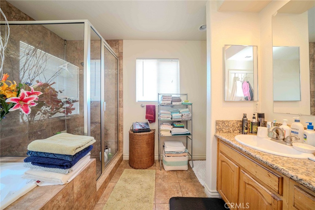 11522 Ponderosa Road Pinon Hills, CA 92372 - Photo 33 of 46 a bathroom with a sink mirror and a shower