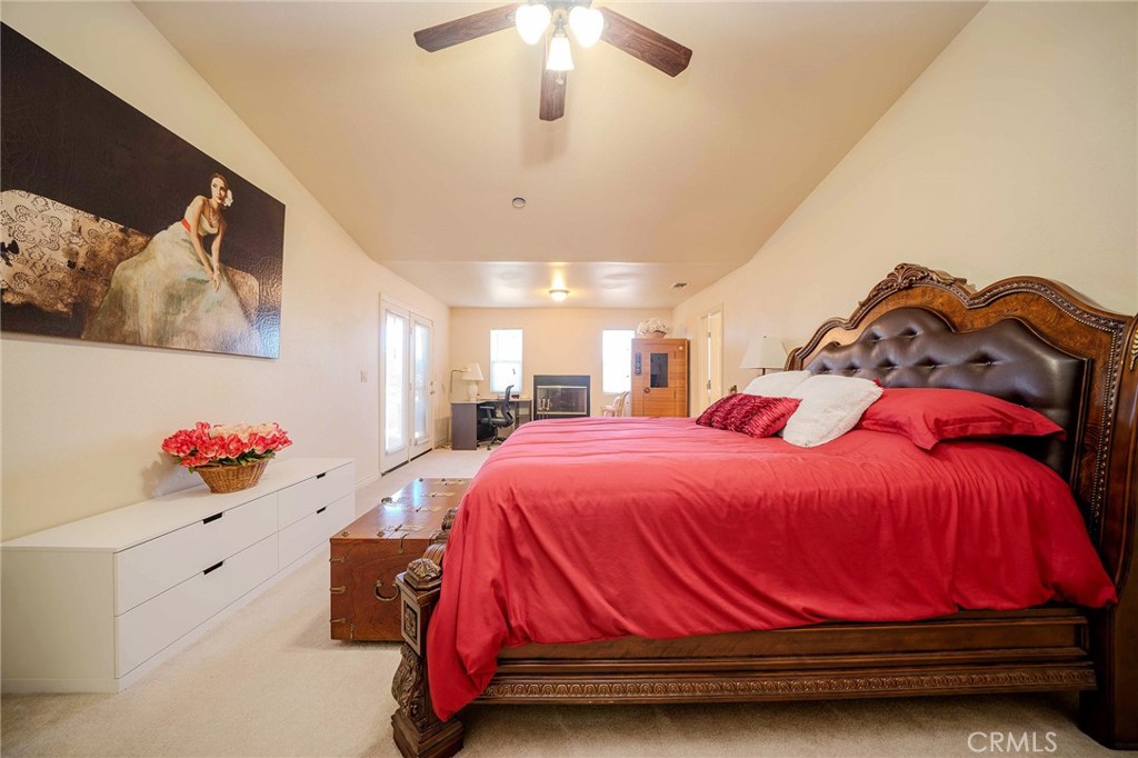 11522 Ponderosa Road Pinon Hills, CA 92372 - Photo 39 of 46 a bedroom with a bed and a chandelier