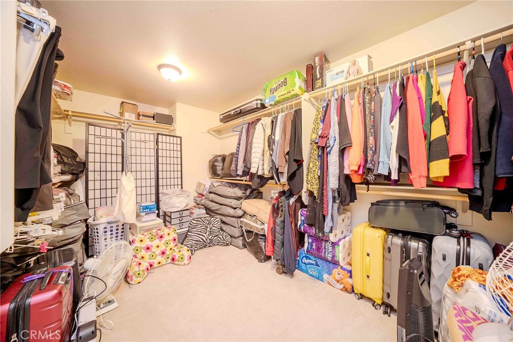 11522 Ponderosa Road Pinon Hills, CA 92372 - Photo 40 of 46 a view of walk in closet with clothes and shoes