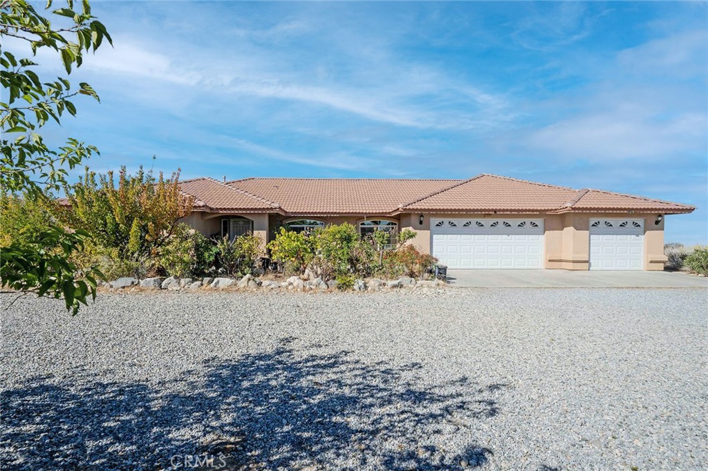 11522 Ponderosa Road Pinon Hills, CA 92372 - Photo 5 of 46 a view of a house with a yard and mountain in the background