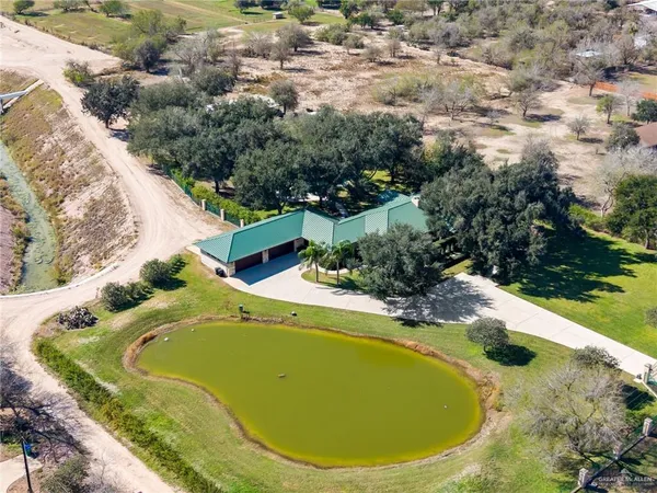 an aerial view of a house with swimming pool