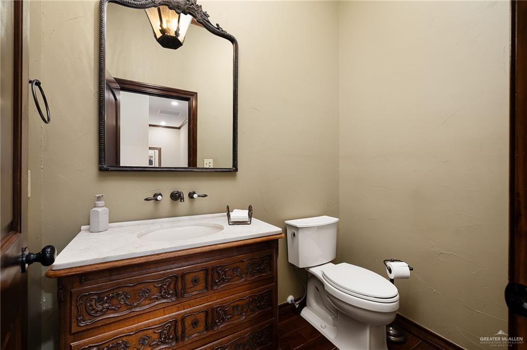 4725 Mile 6 Road McAllen, TX 78504 - Photo 27 of 45 a bathroom with a toilet sink and mirror