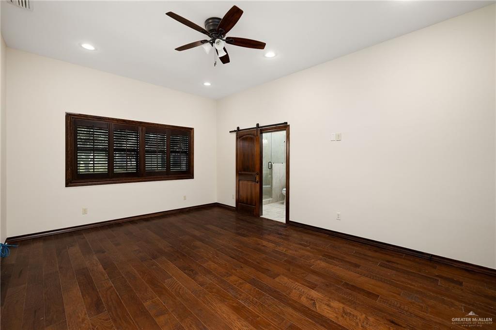 4725 Mile 6 Road McAllen, TX 78504 - Photo 37 of 45 an empty room with wooden floor and windows