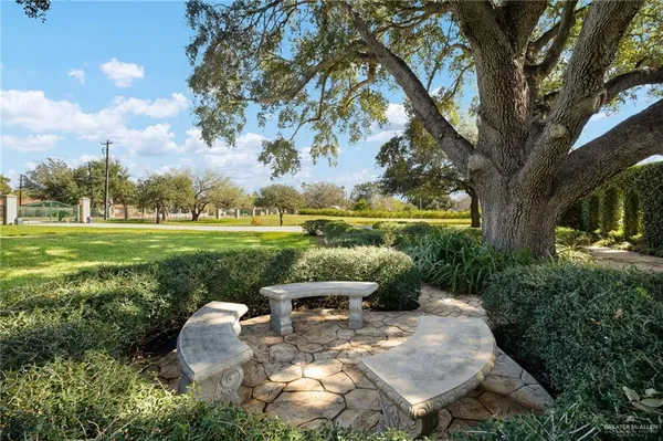 a view of a garden with lawn chairs
