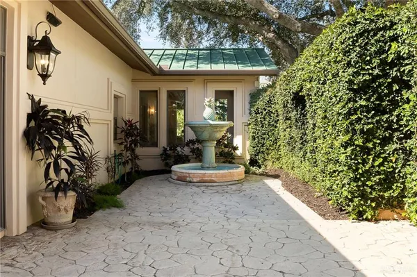 a view of a house with patio and a yard