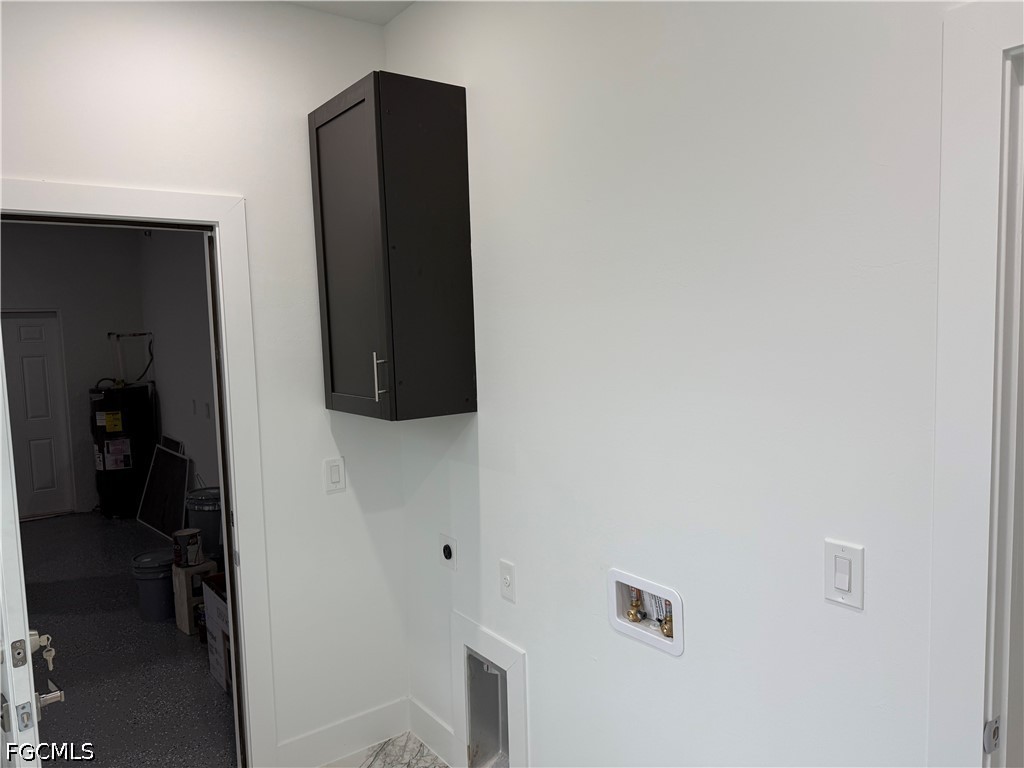 3203 24th Street Southwest Lehigh Acres, FL 33976 - Photo 10 of 19 a room with closet and a flat screen tv