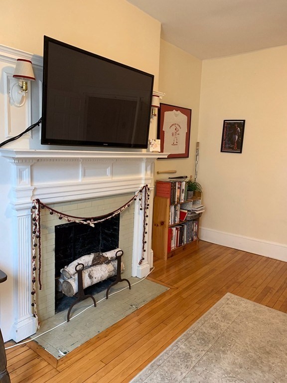 16 Royce Road, Unit 5 Boston, MA 02134 - Photo 1 of 10 a living room with furniture and a fireplace