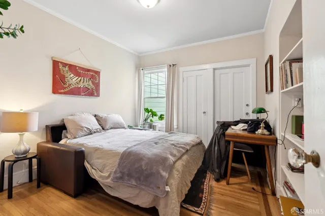 a bedroom with a bed and a desk