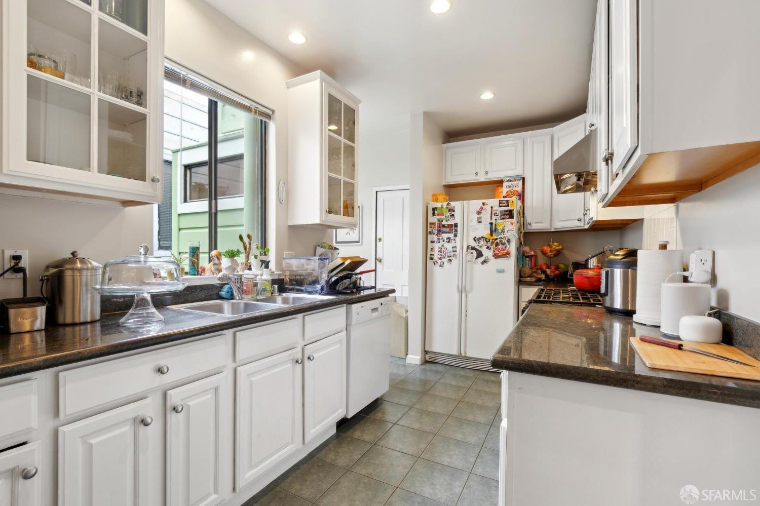 368 Funston Avenue San Francisco, CA 94118 - Photo 6 of 16 a kitchen with stainless steel appliances granite countertop a sink and cabinets