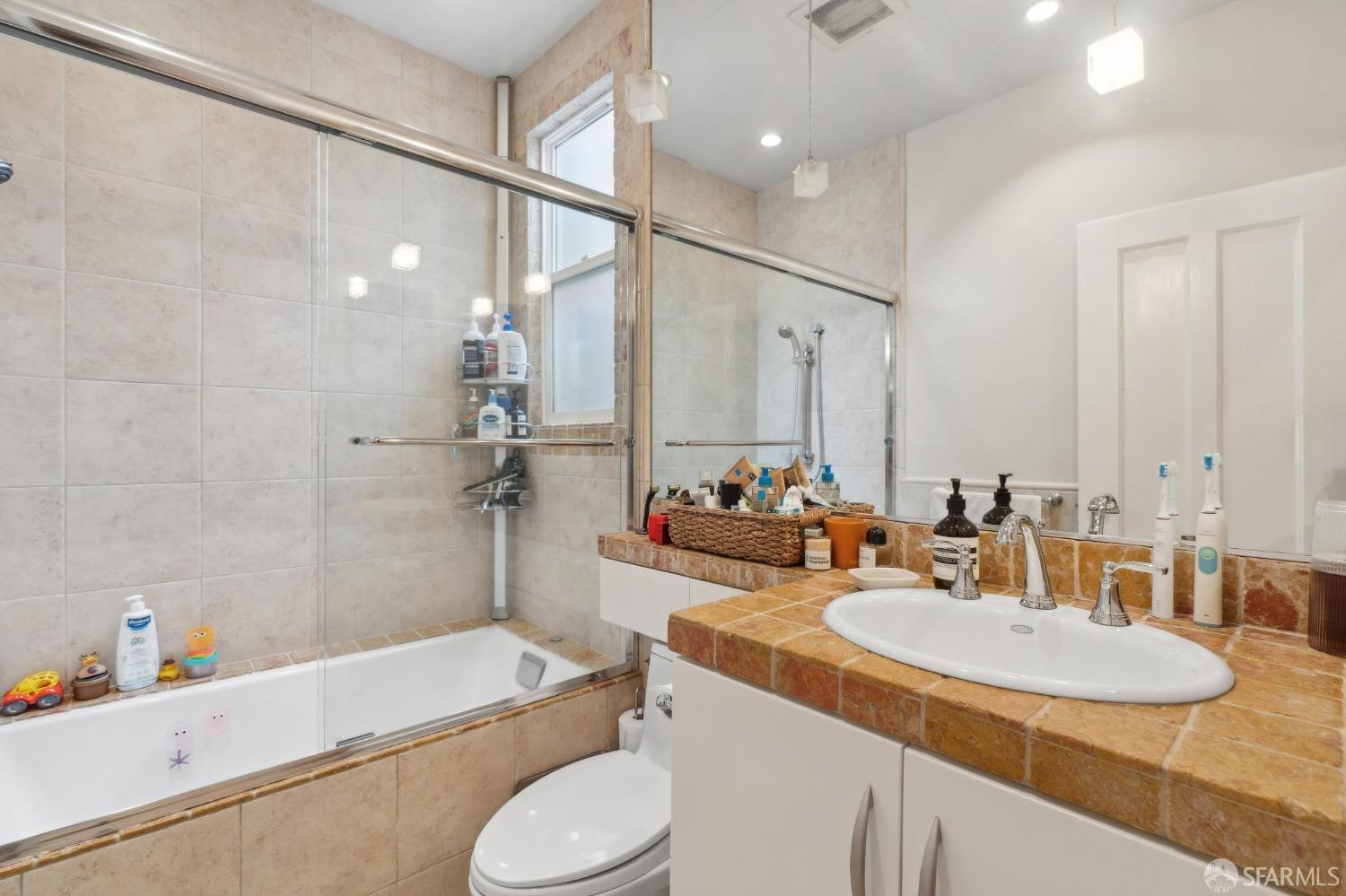 368 Funston Avenue San Francisco, CA 94118 - Photo 8 of 16 a bathroom with a granite countertop sink toilet and shower