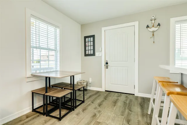 a view of a livingroom with wooden floor and a window