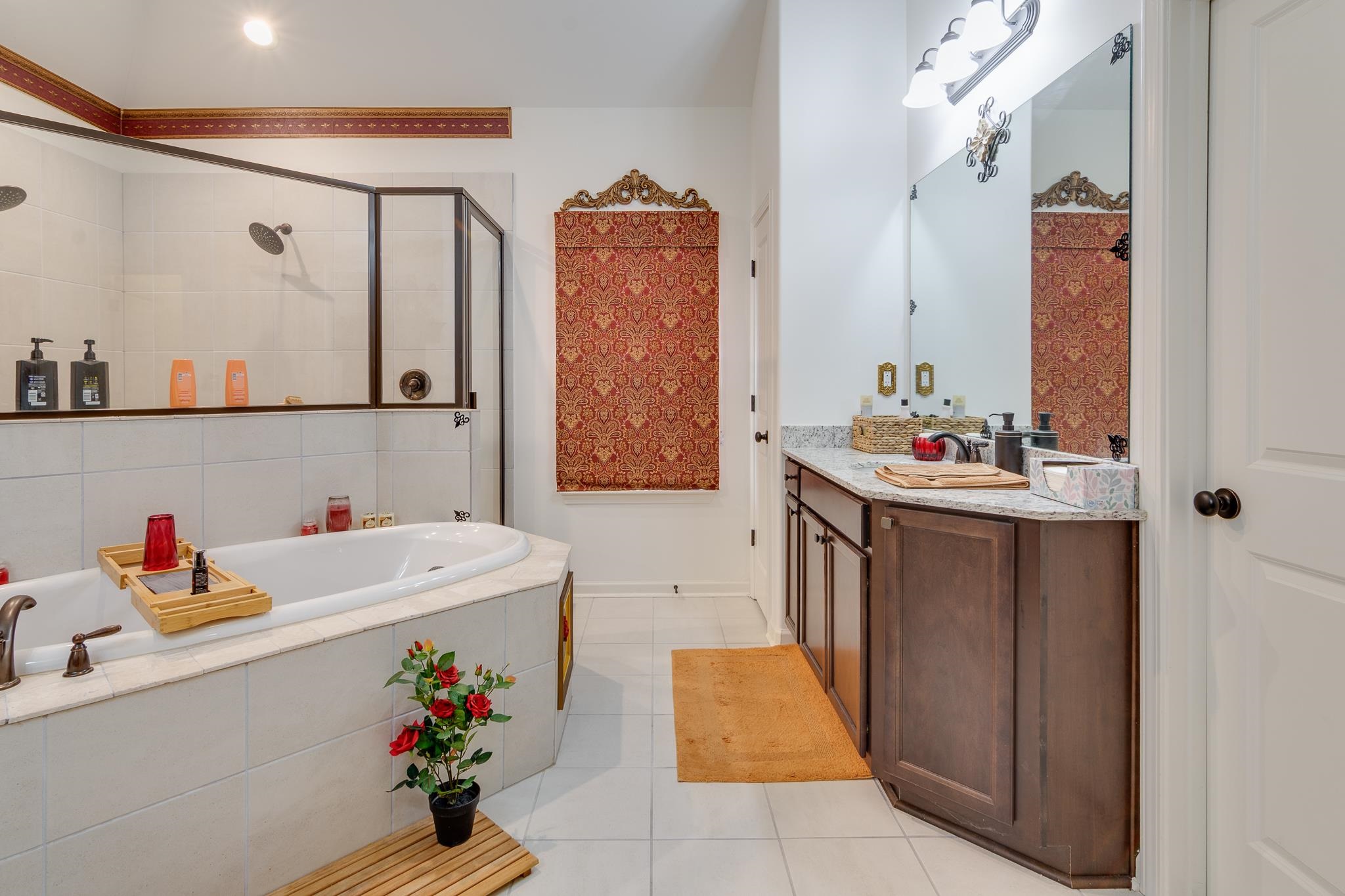 135 Chesnut Rdg Drive Oakland, TN 38060 - Photo 22 of 36 Bathroom featuring vanity, a shower stall, light tile patterned floors, and a garden tub