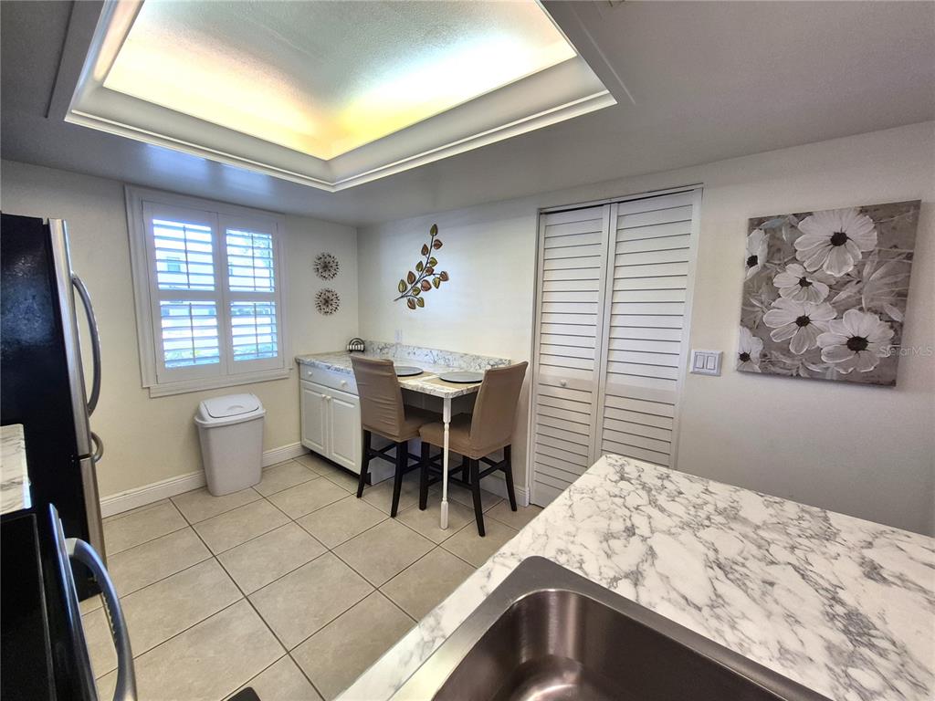 107 Windward Place, Unit 107 Oldsmar, FL 34677 - Photo 16 of 34 a bedroom with a bed and a table in it with window