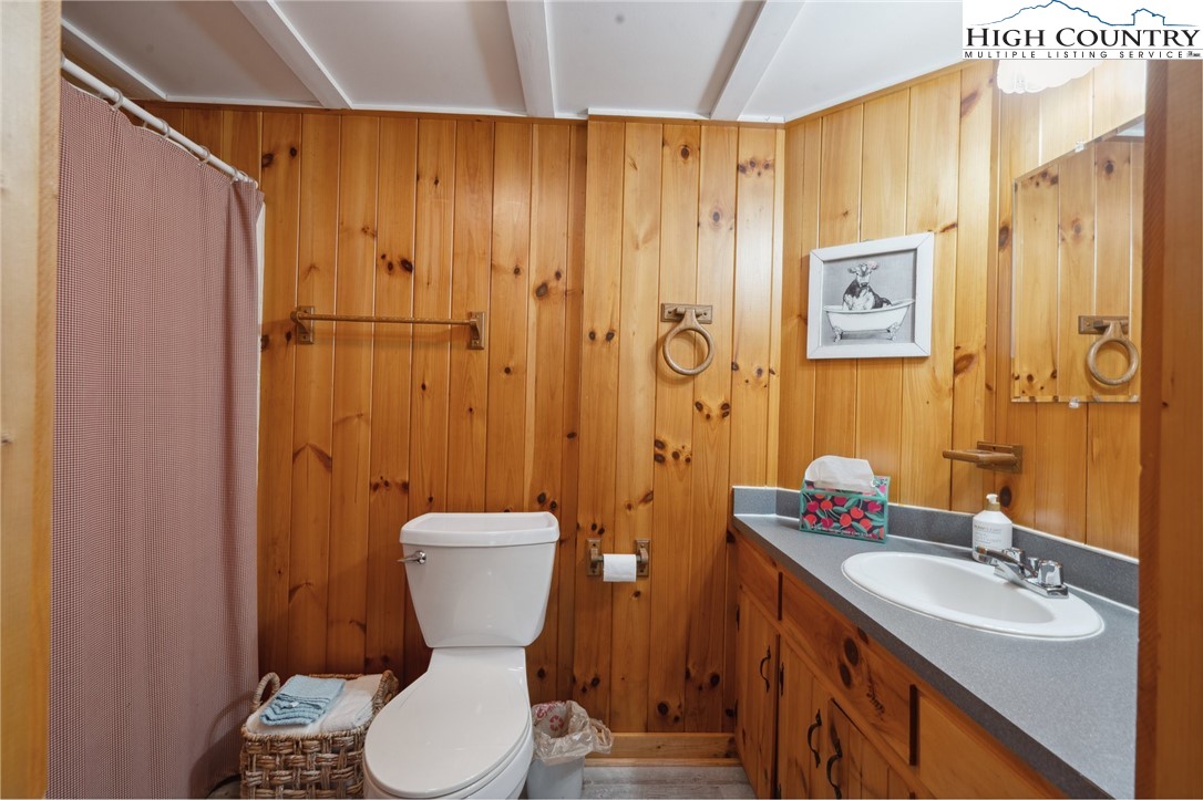 710 River Hills Road Lansing, NC 28643 - Photo 23 of 38 a bathroom with a granite countertop toilet sink and shower
