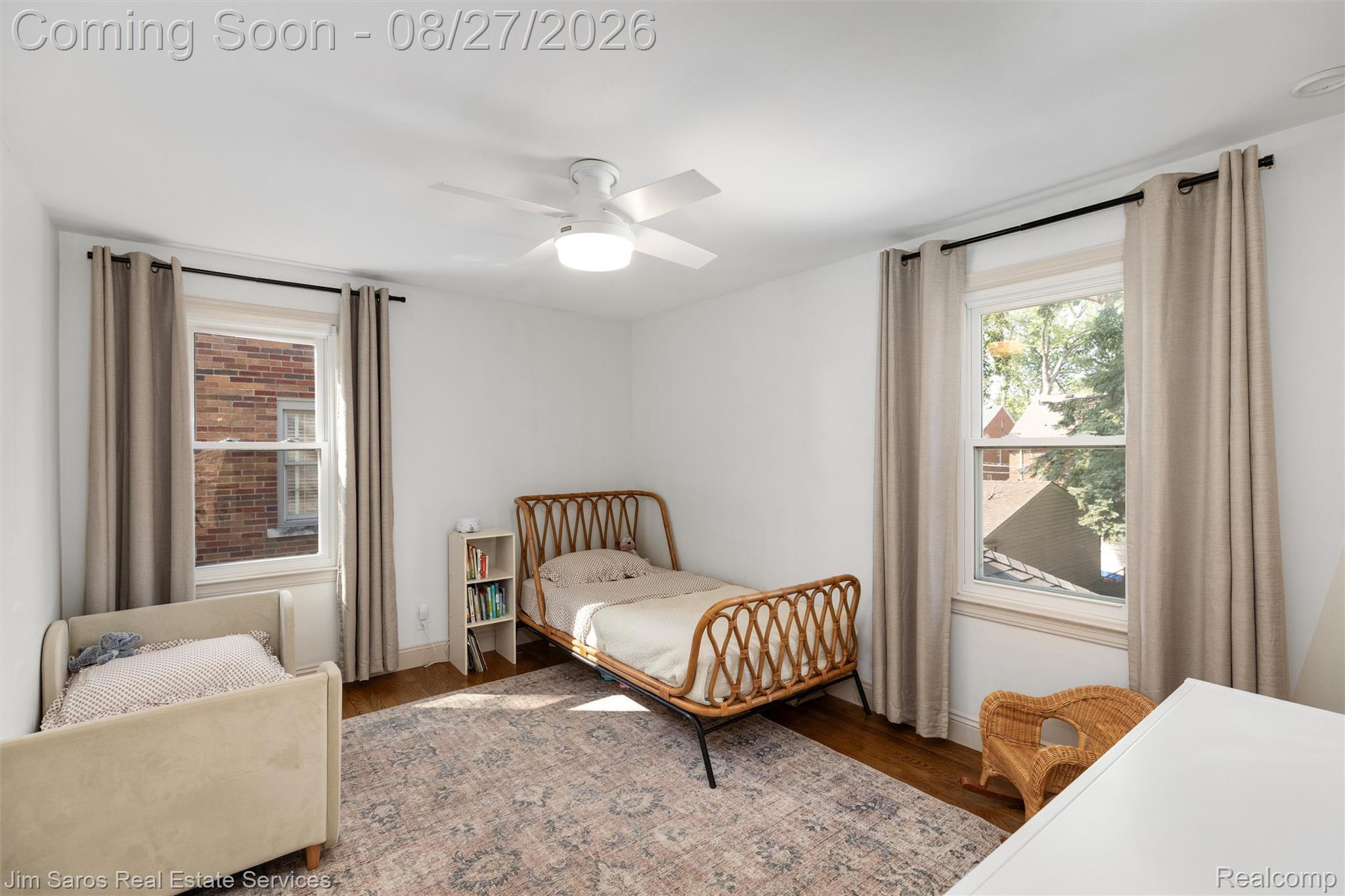 276 Moran Road Grosse Pointe, MI 48236 - Photo 16 of 23 Hardwood flooring, white walls, two single-hung windows, and a ceiling fan with integrated lighting
