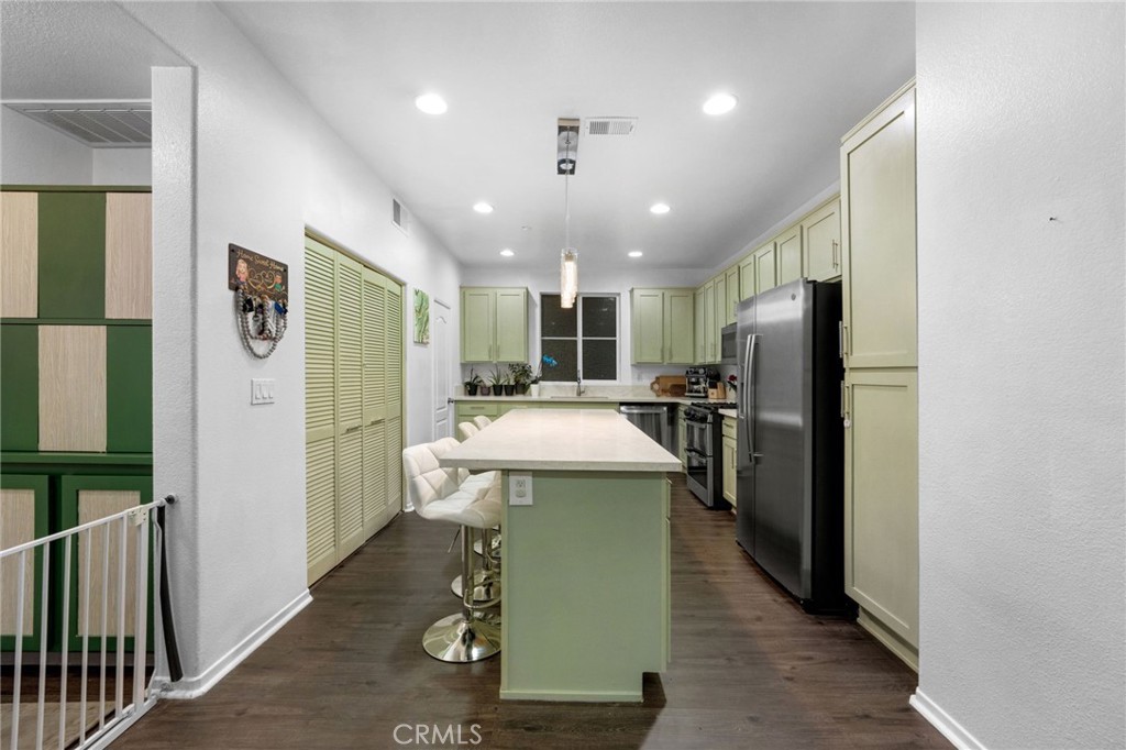 1572 Hackberry Place Chula Vista, CA 91915 - Photo 11 of 38 a kitchen with refrigerator and chairs
