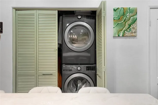 a view of a bedroom with washer and dryer