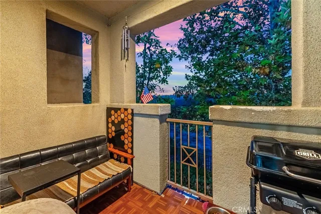 a view of a patio with two chairs and a potted plant