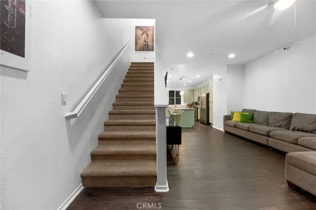 a living room with furniture and stairs