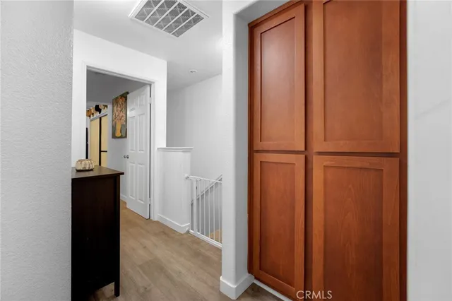 a view of a hallway with wooden floor