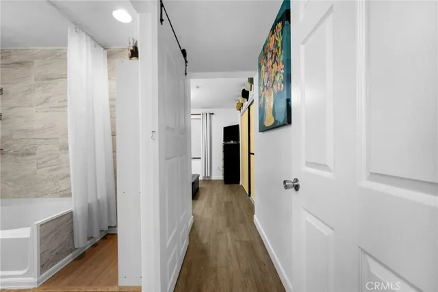 a view of hallway with wooden floor