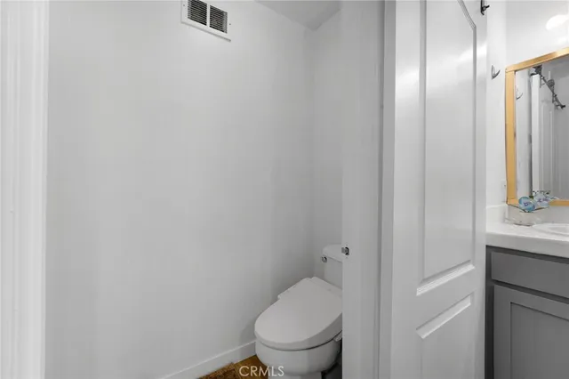 a white toilet sitting next to a bathroom sink