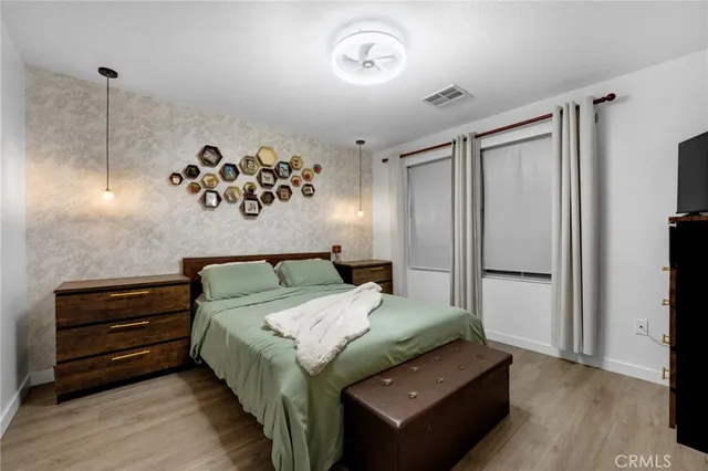 a bedroom with a bed and a dresser