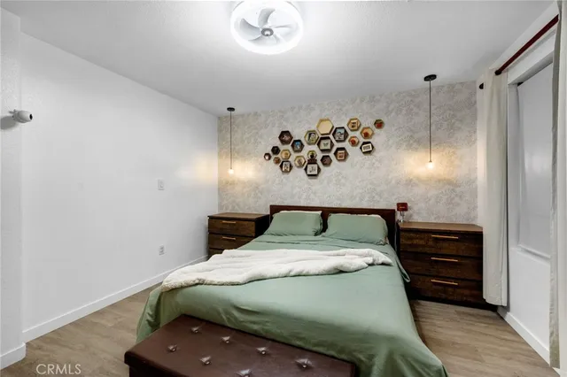 a bed sitting in a bedroom and chandelier