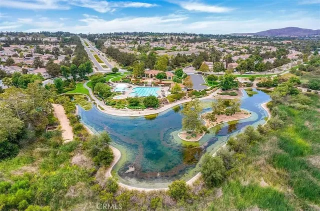 an aerial view of a houses with a swimming pool