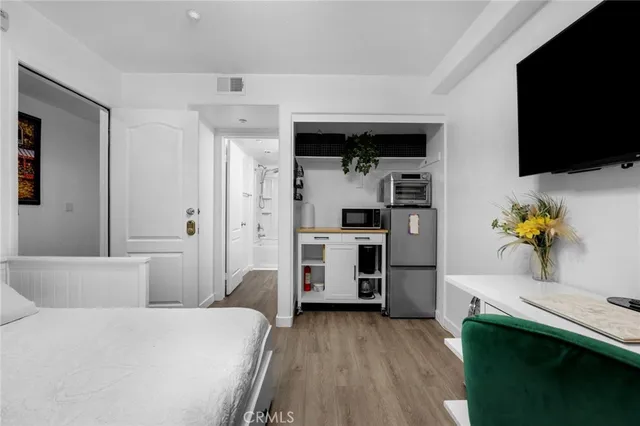 a bedroom with a bed and a flat screen tv