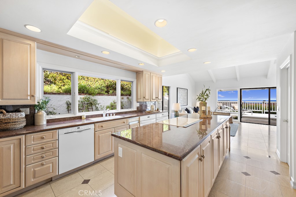 23242 Palawan Circle Dana Point, CA 92629 - Photo 11 of 34 a large kitchen with kitchen island a large window a sink and counter space