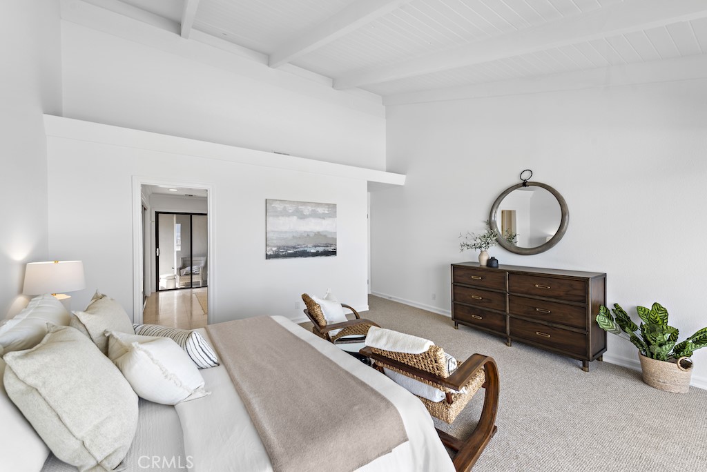 23242 Palawan Circle Dana Point, CA 92629 - Photo 16 of 34 a bedroom with a bed and a chandelier