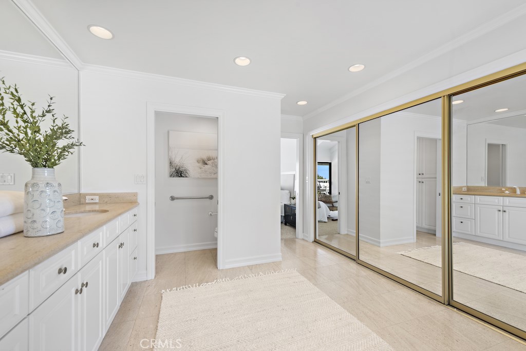 23242 Palawan Circle Dana Point, CA 92629 - Photo 17 of 34 a bathroom with a granite countertop sink a mirror and a shower