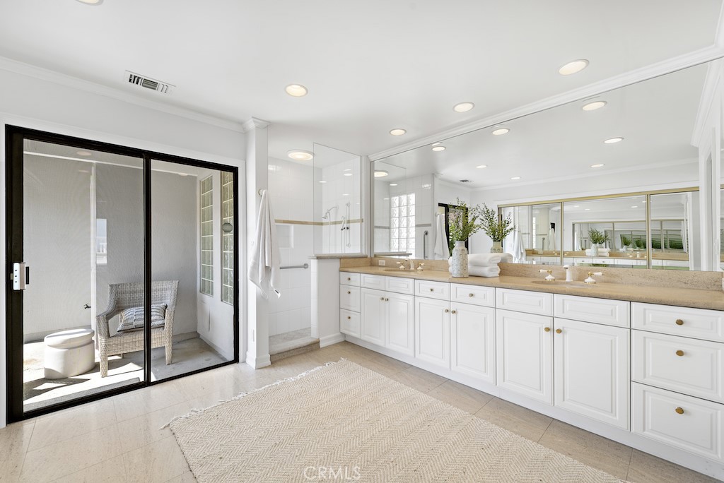 23242 Palawan Circle Dana Point, CA 92629 - Photo 18 of 34 a large bathroom with a large mirror vanity and shower