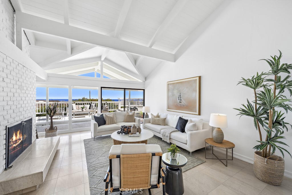 23242 Palawan Circle Dana Point, CA 92629 - Photo 5 of 34 a living room with fireplace furniture and a large window