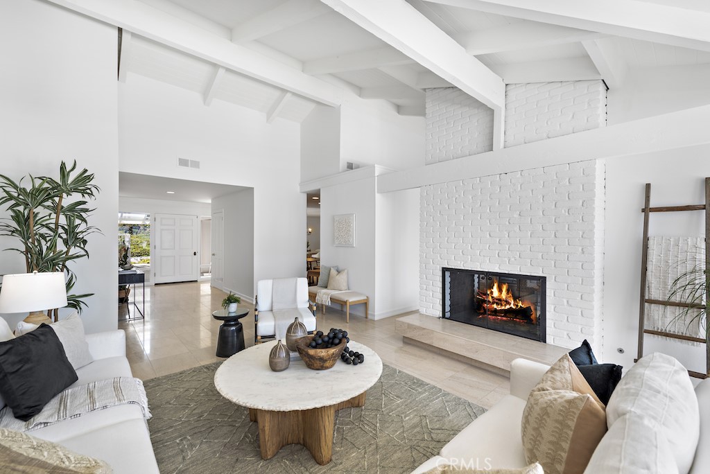 23242 Palawan Circle Dana Point, CA 92629 - Photo 6 of 34 a living room with furniture a fireplace and a table