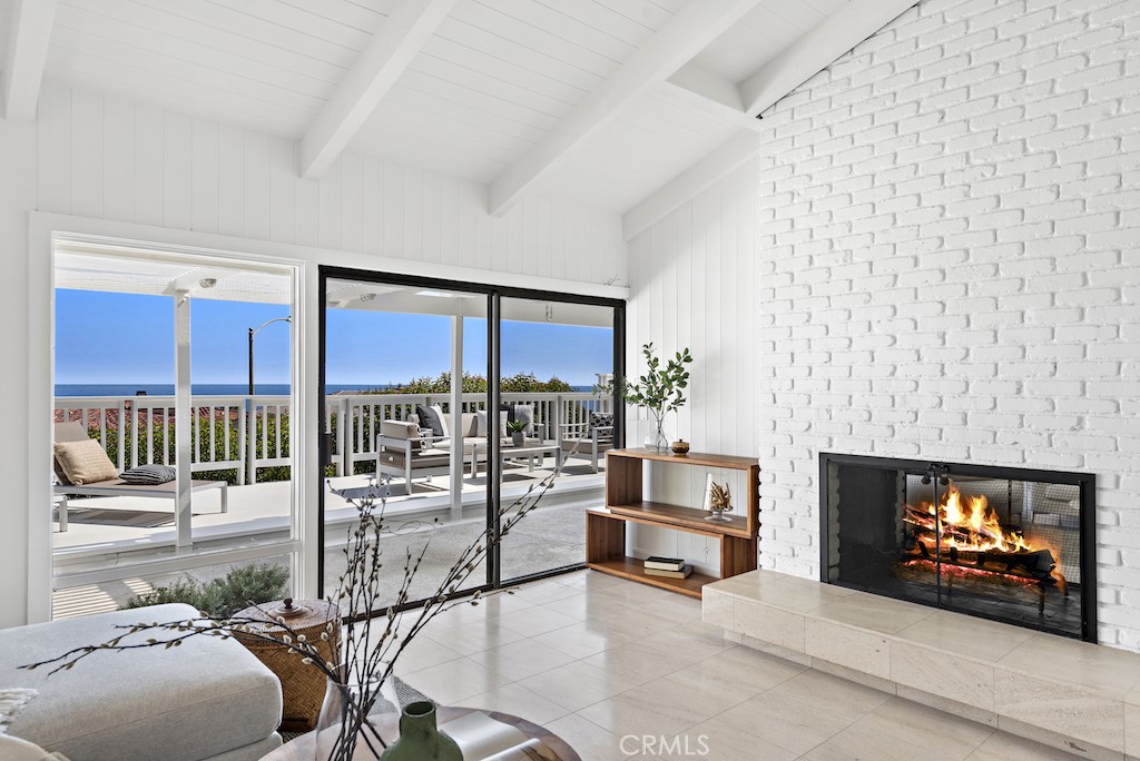 23242 Palawan Circle Dana Point, CA 92629 - Photo 8 of 34 a living room with furniture a flat screen tv and a fireplace