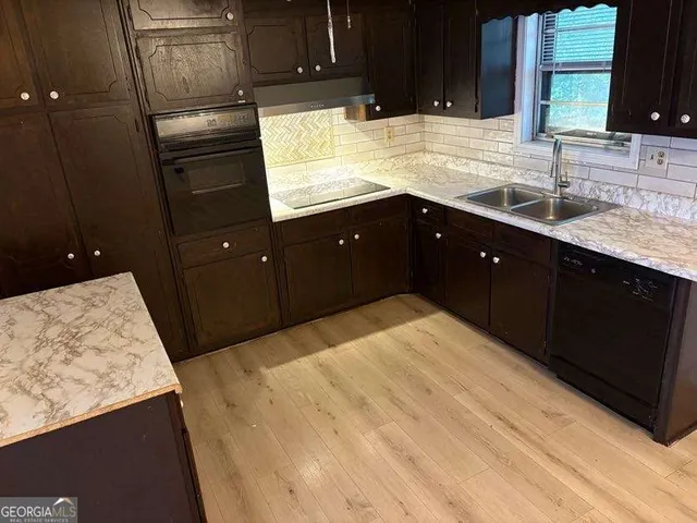 a kitchen with a sink and a refrigerator