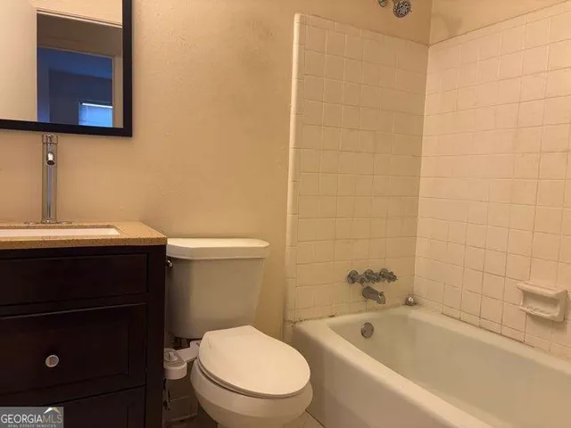 a bathroom with a sink a toilet and bathtub