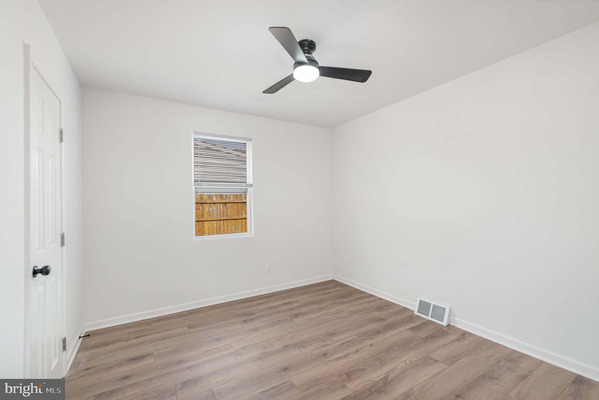 7 Terrace Road Essex, MD 21221 - Photo 16 of 25 an empty room with wooden floor and ceiling fan